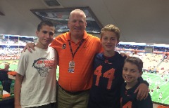 Pete Moore with (l-r) son Jack Moore and stepsons Tyler and Leo Johnson in the Syracuse football press box.